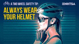 A cyclist putting on a bicycle helmet.